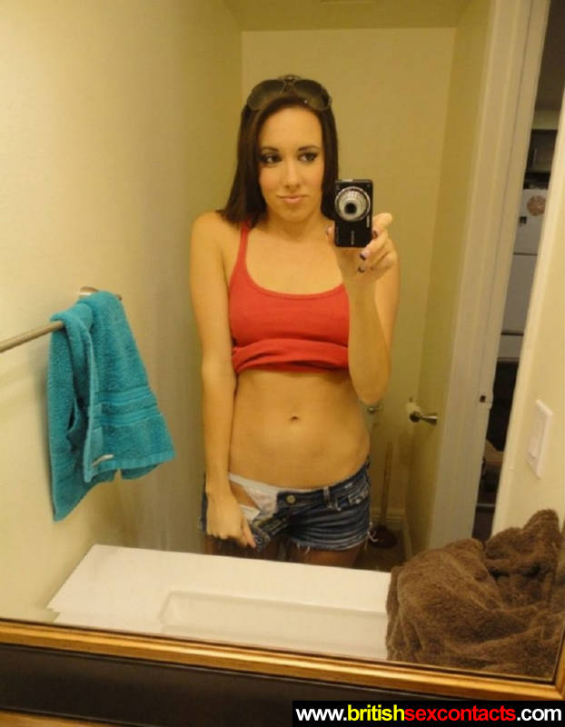 Cute brunette stripping off in bathroom